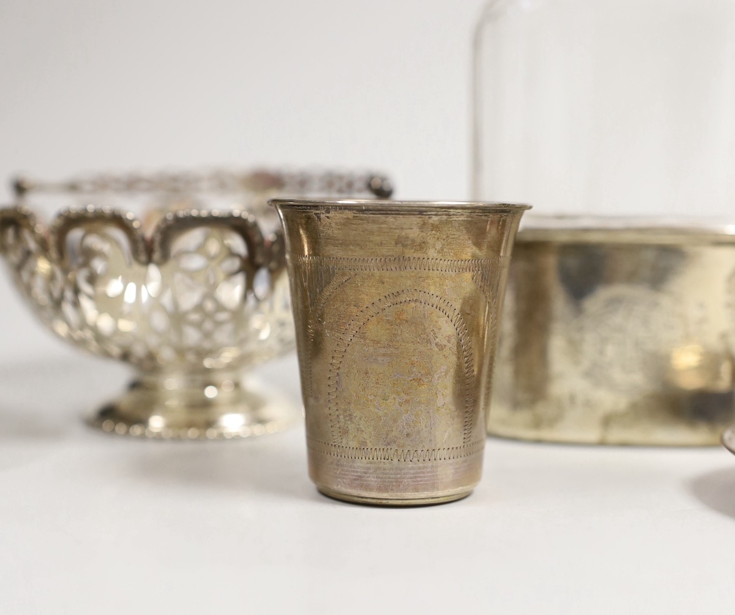 A pair of Edwardian pierced silver bonbon baskets, Nathan & Hayes, Birmingham, 1909, diameter 10.1cm, a pair of silver bonbon dishes, an Edwardian silver mounted glass hip flask, by Charles & George Asprey, London, 1908